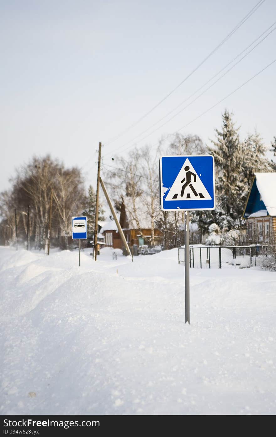 Pedestrian crossing traffic sign on winter road