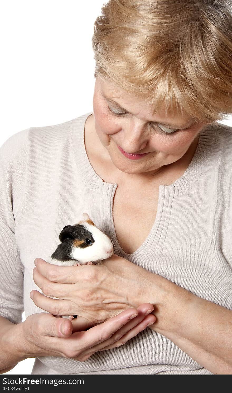 Senior woman holding guinea pig - pet therapy