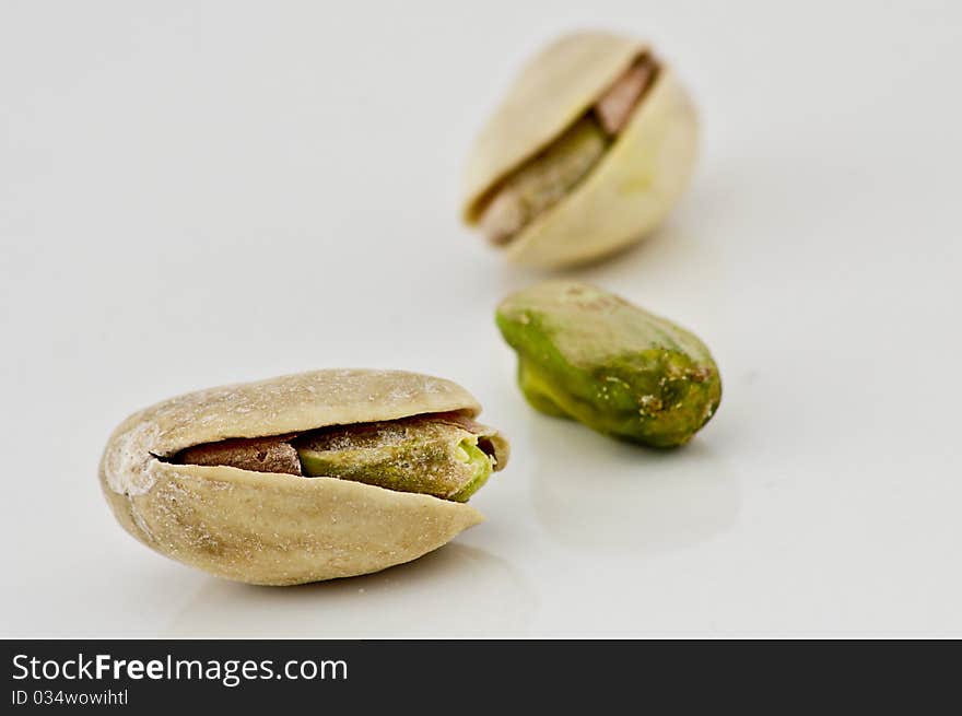 Salted pistachios isolated on white background