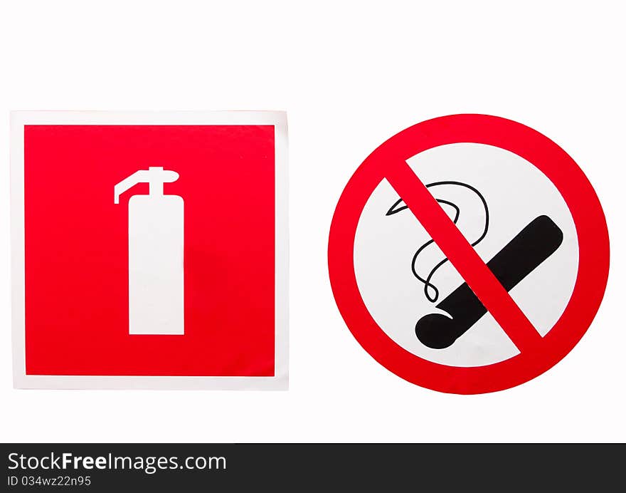 No smoking sign and a fire extinguisher on the wall. No smoking sign and a fire extinguisher on the wall