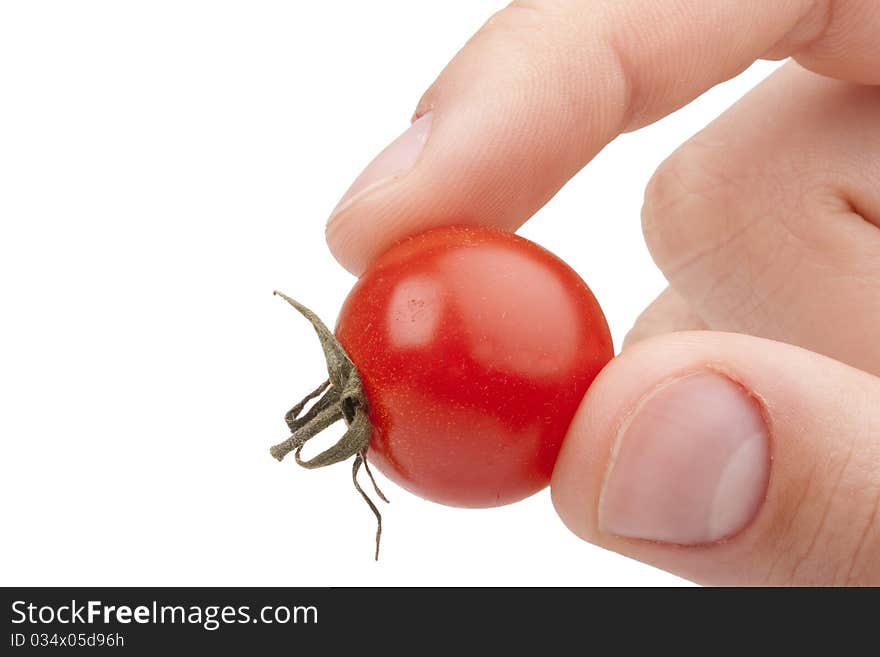 A small red tomato in the men's hand.