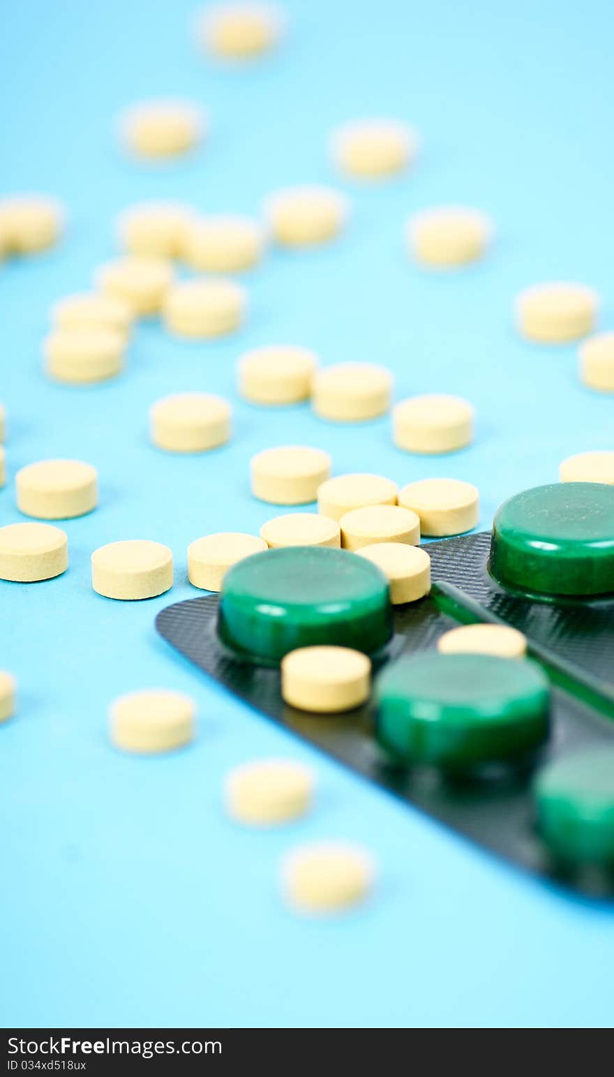 Tablets and capsules on blue background