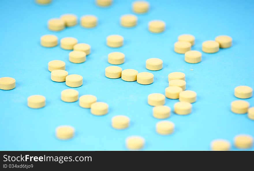 Yelloy tablets on blue background