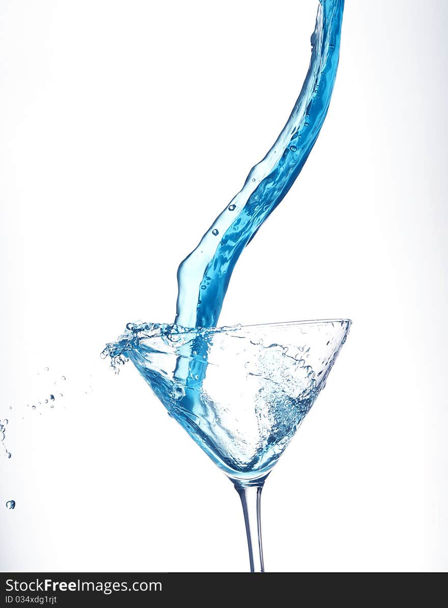 Splashing blue cocktail on the white background