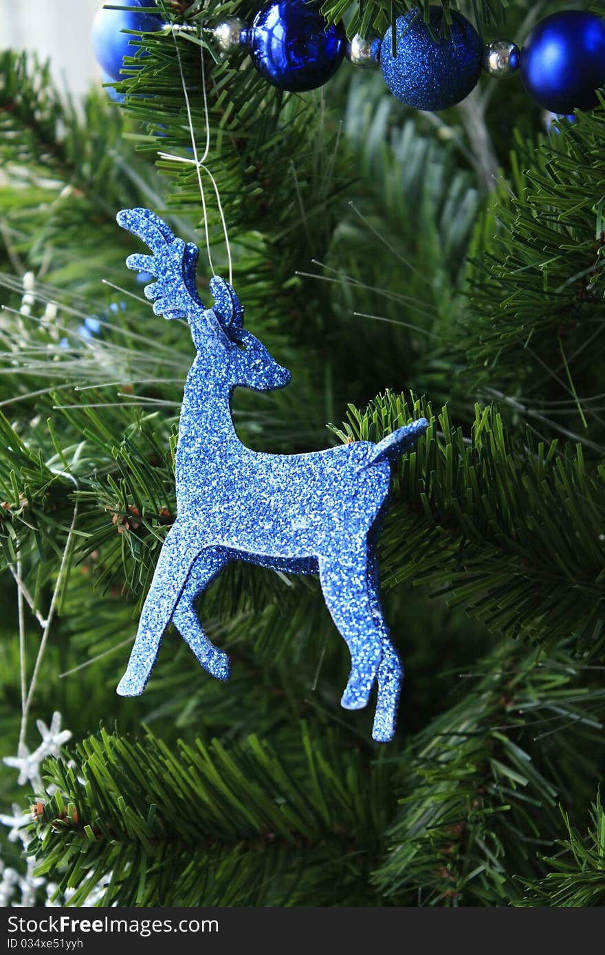 Blue sparkle raindeer christmas ornament  hanging from tree. Blue sparkle raindeer christmas ornament  hanging from tree