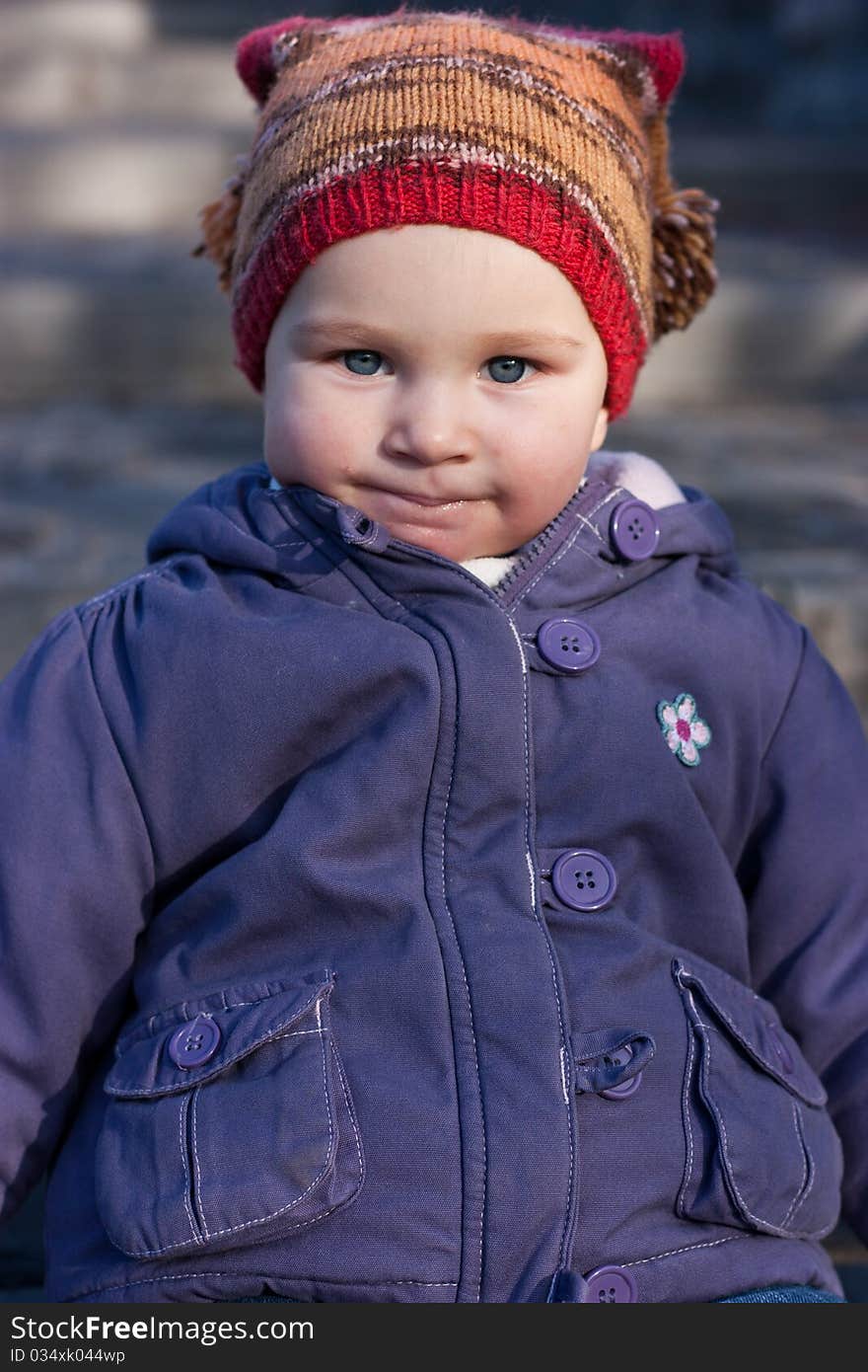 Beautiful baby sitting on stairs