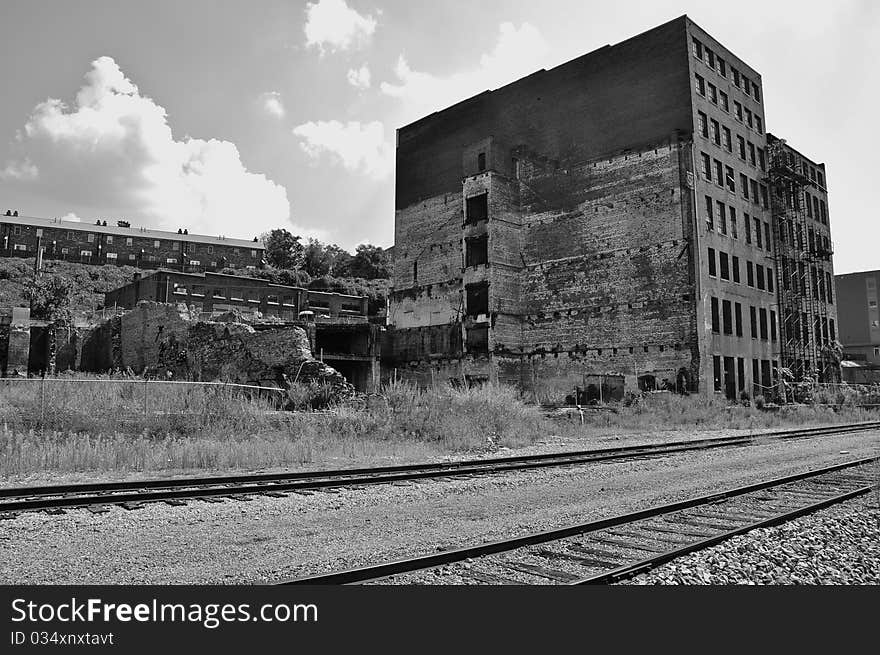 Dilapidated factory near the railroad tracks. Dilapidated factory near the railroad tracks