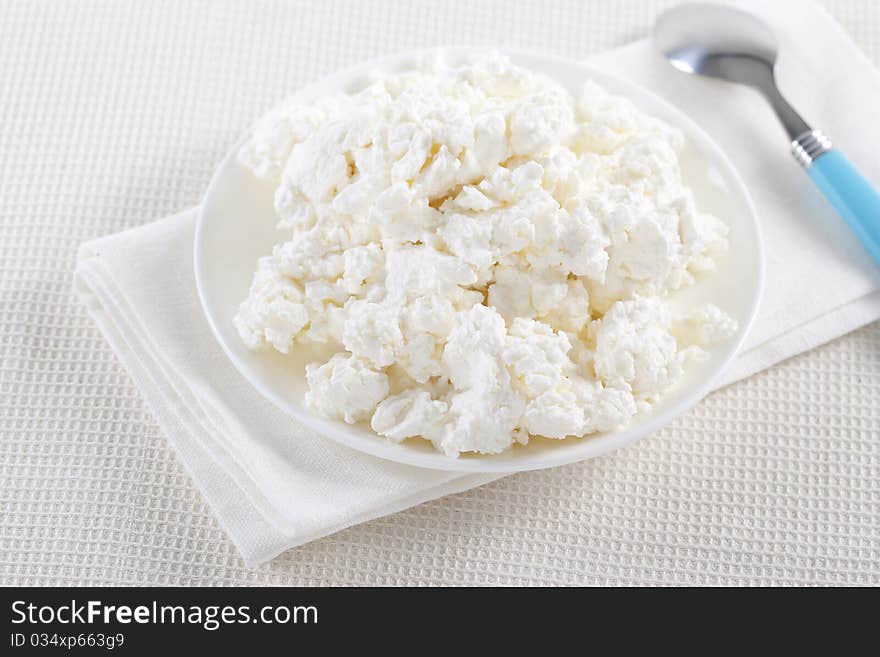 Fresh cottage cheese on the white plate