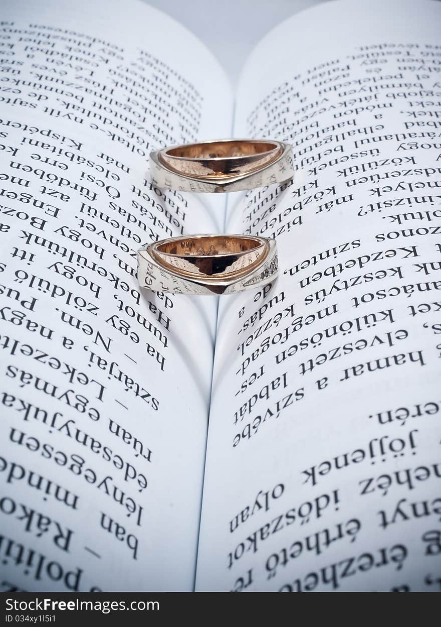 Two wedding rings on a book