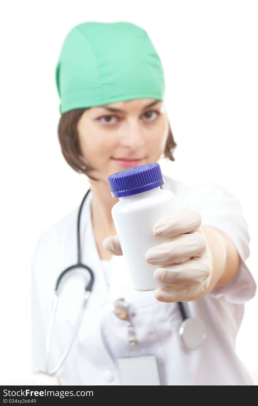 Young lady doctor with pills in her hand