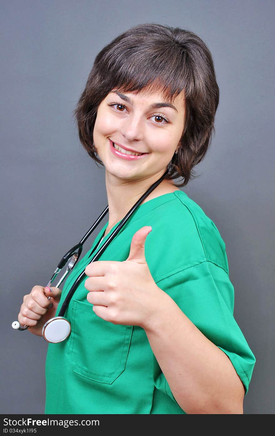 Attractive lady doctor whit thumb up