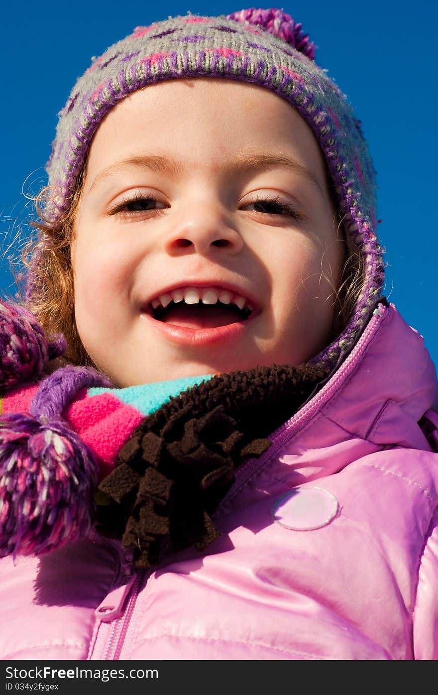 Young caucasian girl dressed up for winter, smiling. Young caucasian girl dressed up for winter, smiling