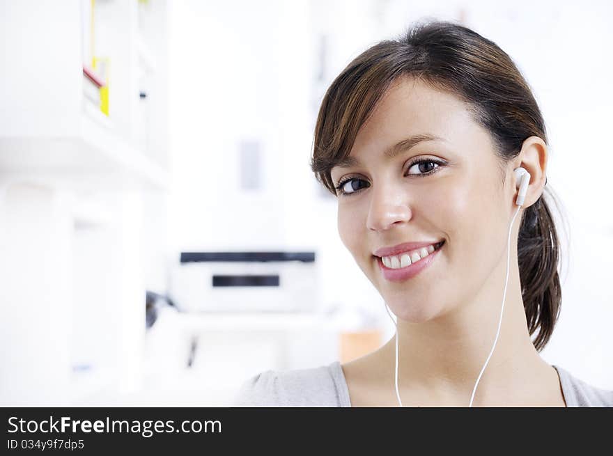 Young woman listening music in home interior