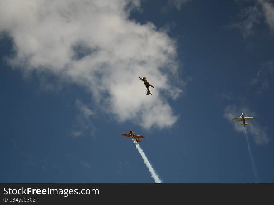 Three airplanes performing a stunt