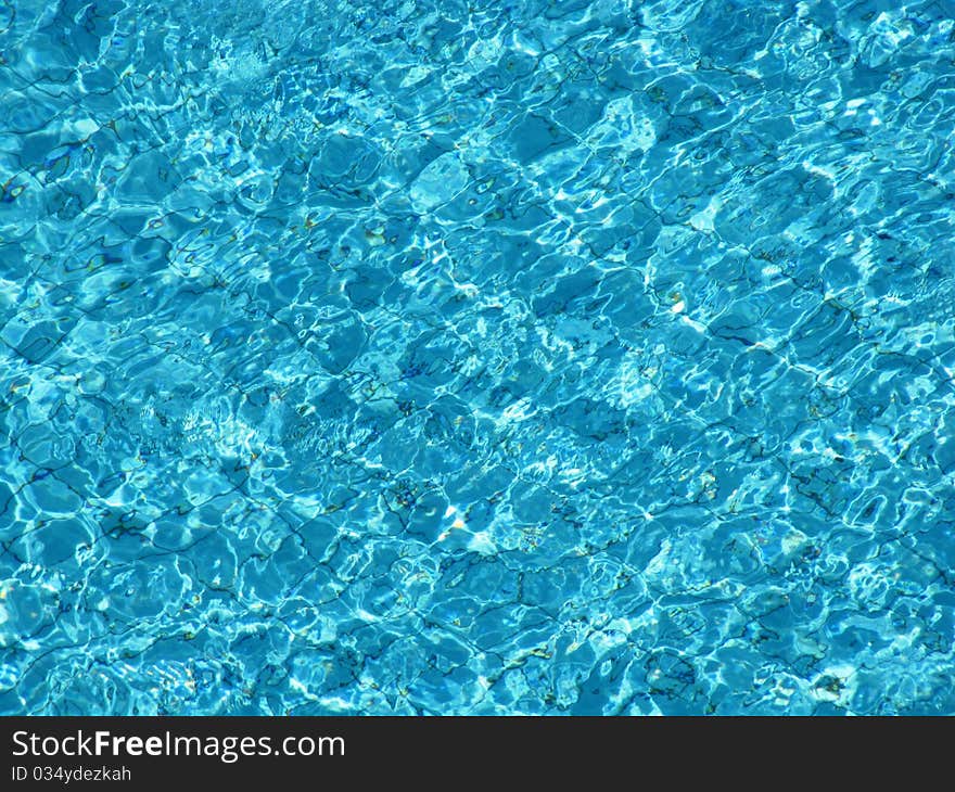 Texture of the Clean Blue Water in a Pool on a Sunny Day. Texture of the Clean Blue Water in a Pool on a Sunny Day