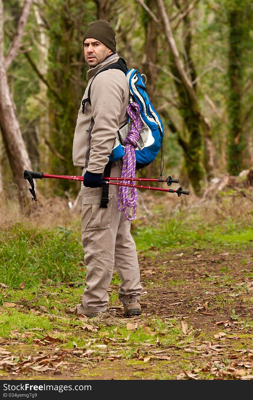 Hiker walking a trail lookin back