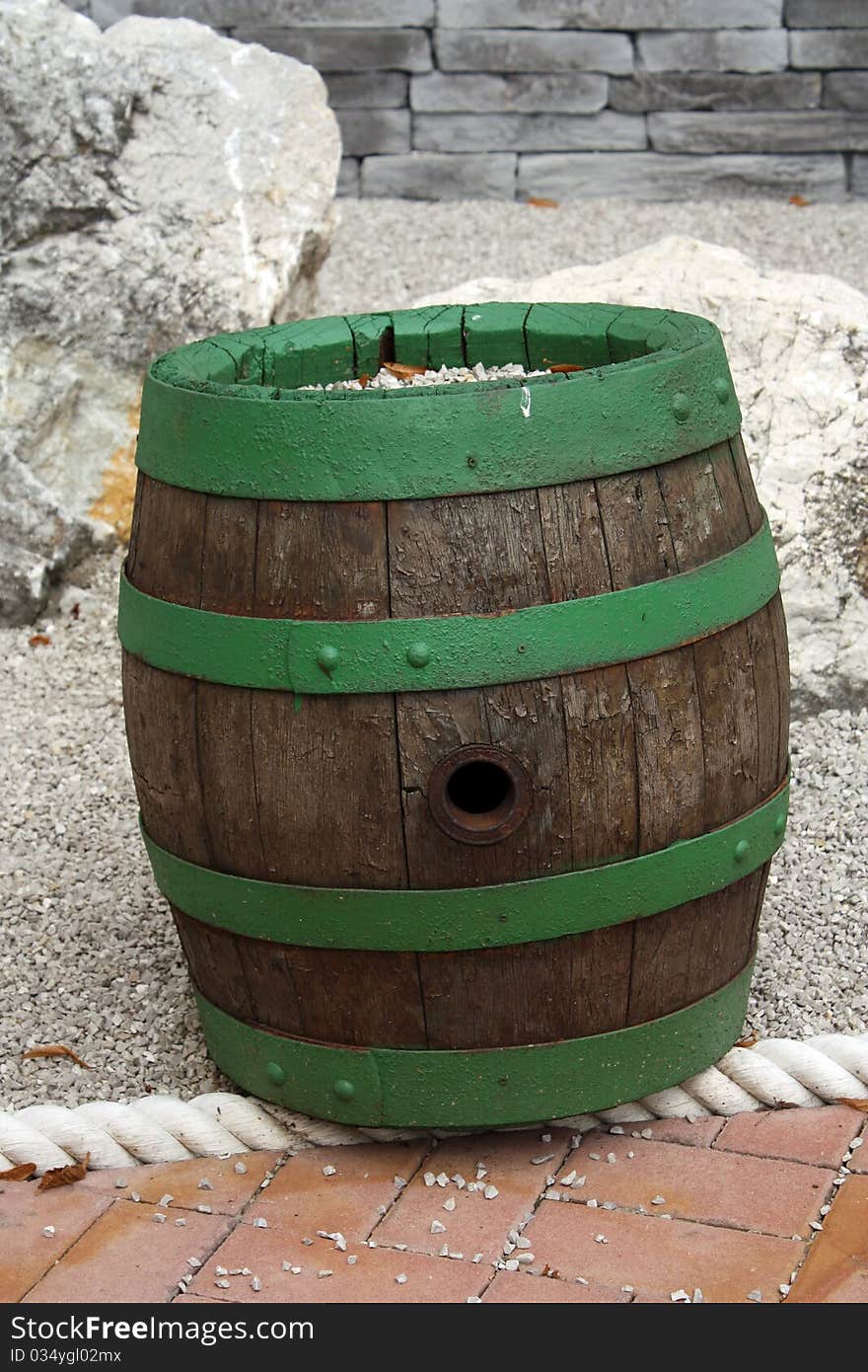 Green wood Barrel, stones on the background