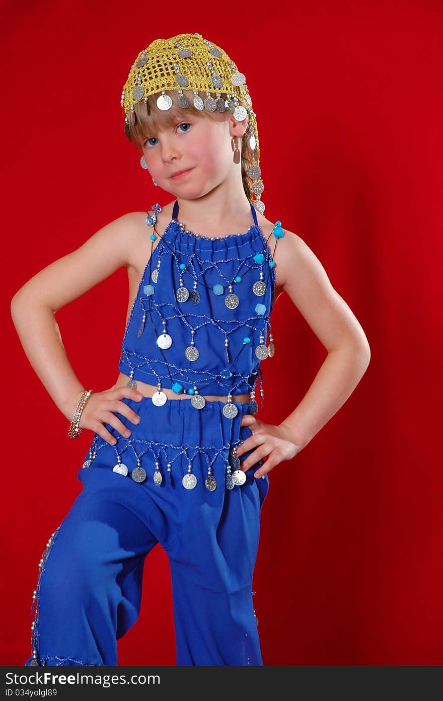 Little girl in oriental costume on a red background