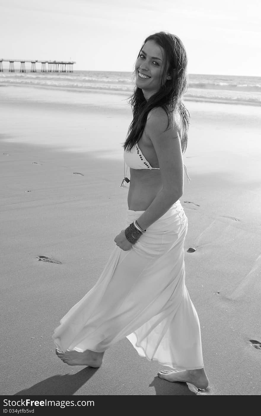 Brunette female model on beach at sunset. Brunette female model on beach at sunset