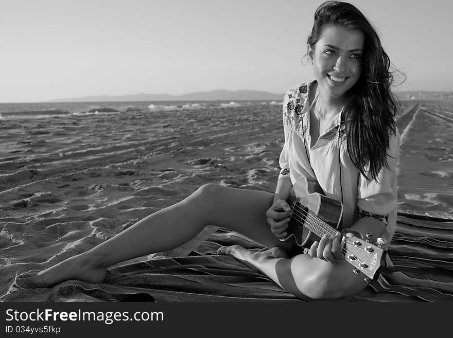 Brunette female model on beach at sunset in black and white. Brunette female model on beach at sunset in black and white