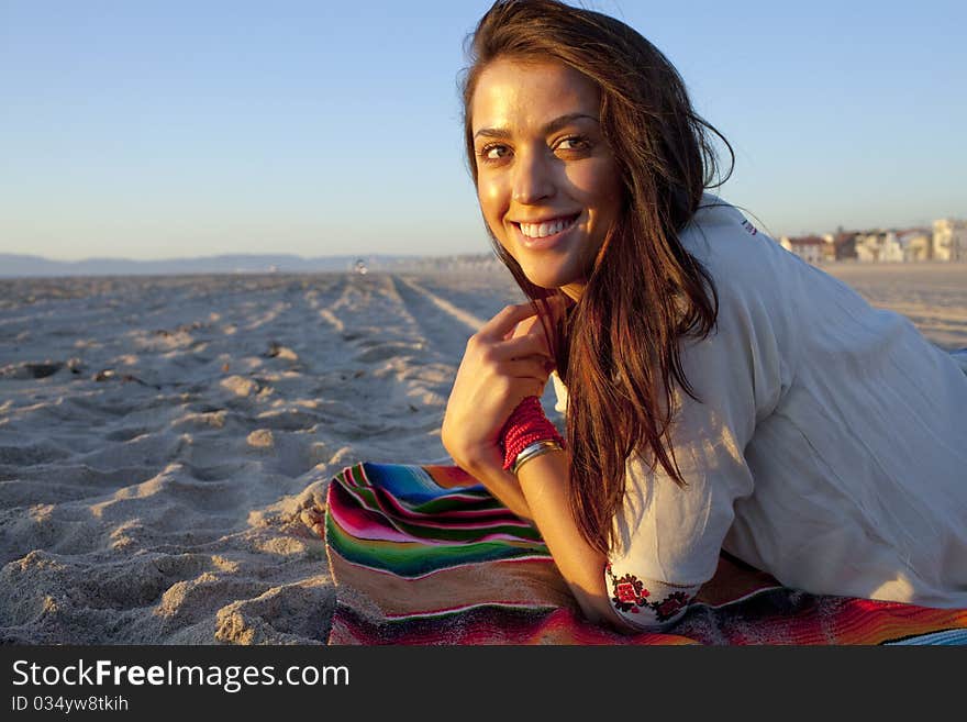 Brunette female model on beach at sunset. Brunette female model on beach at sunset