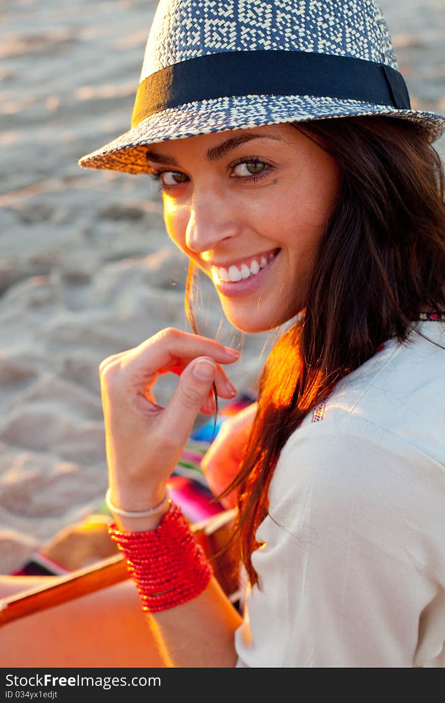 Brunette female model on beach at sunset. Brunette female model on beach at sunset