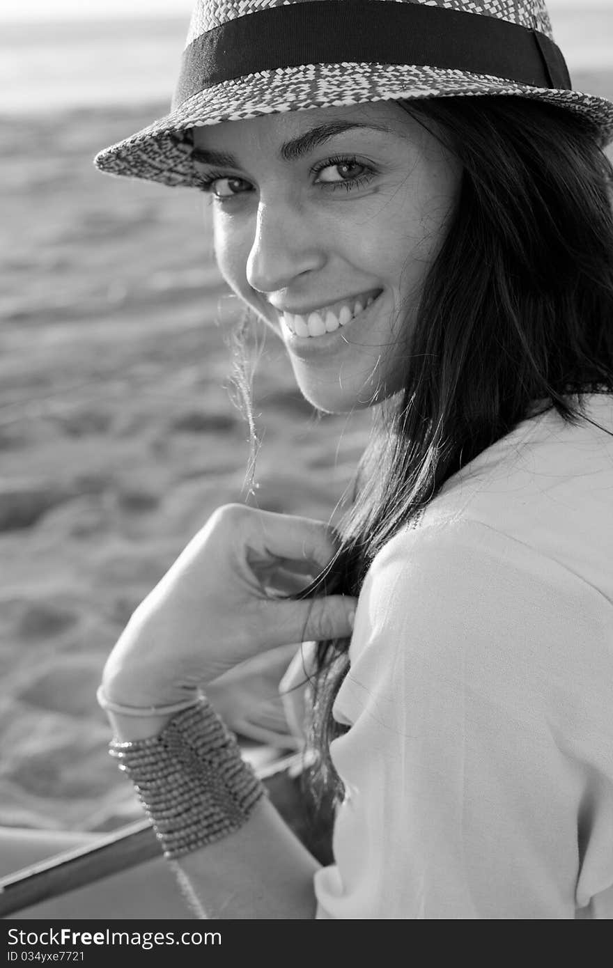 Brunette female model on beach at sunset in black and white. Brunette female model on beach at sunset in black and white