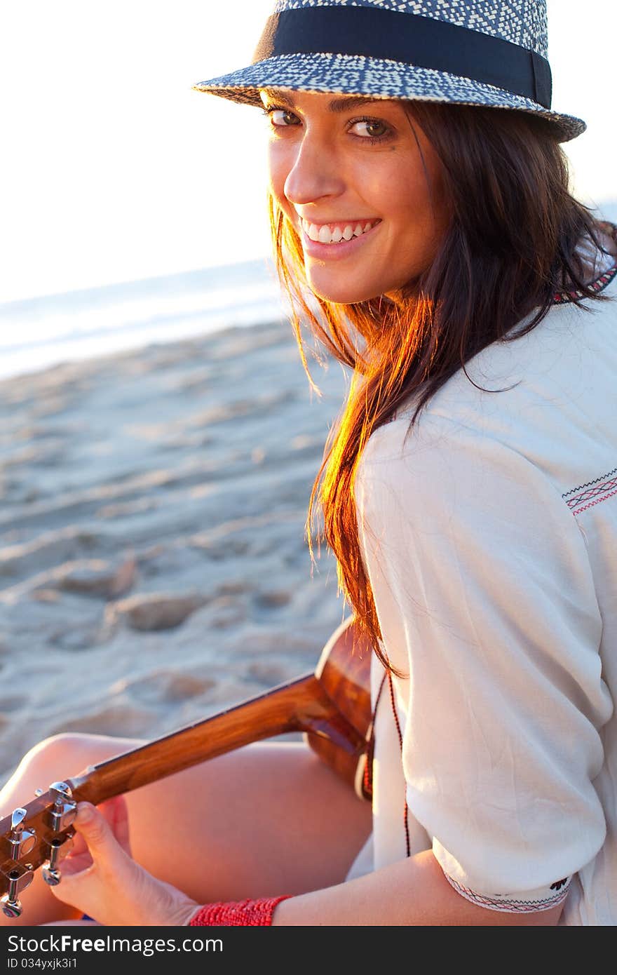 Brunette female model on beach at sunset. Brunette female model on beach at sunset