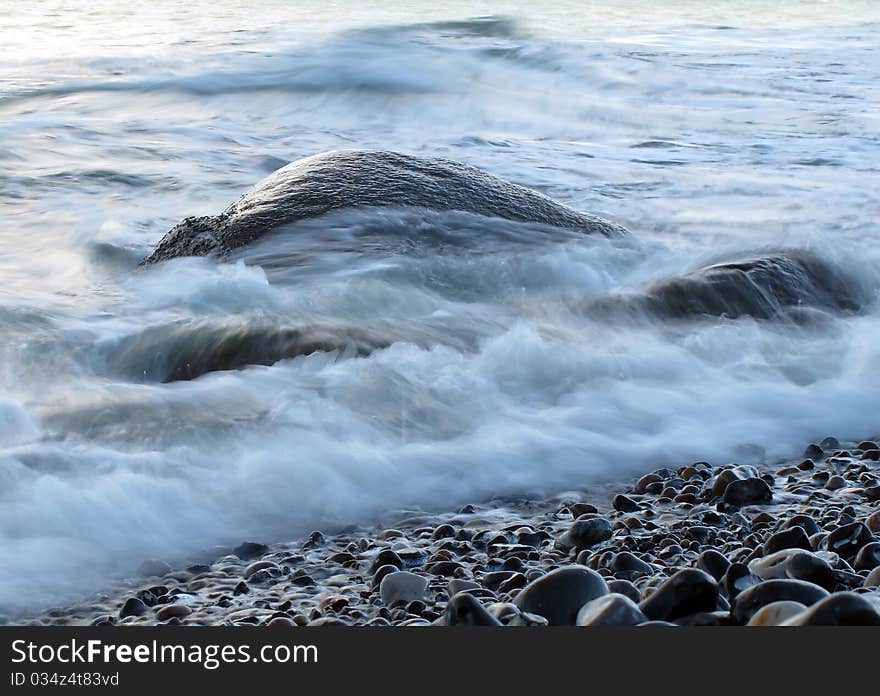 Sea water flows around rocks