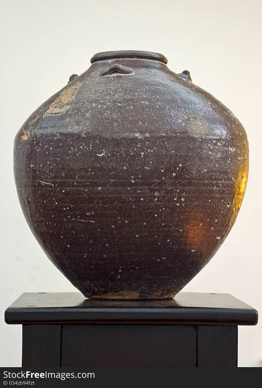 Earthen Pot On A Dark Stand