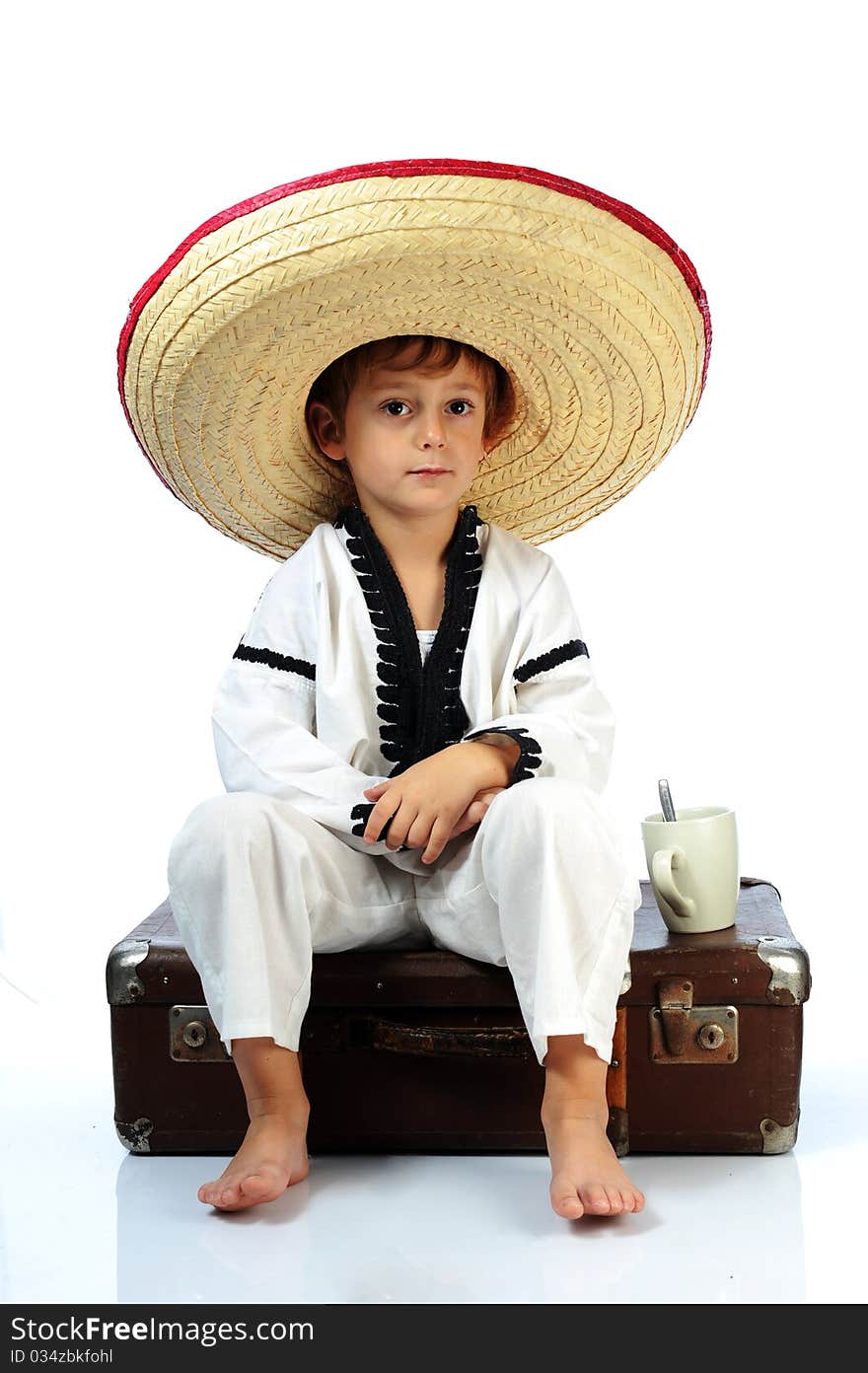 Toddler wearing a large sombrero hat. Toddler wearing a large sombrero hat