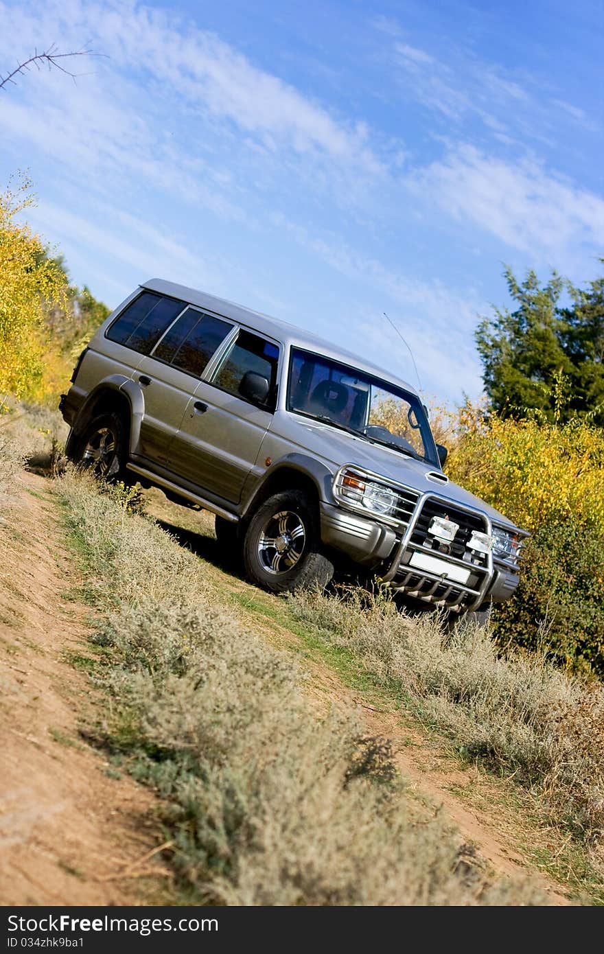 Gray jeep standing on the road on rural landscape. Gray jeep standing on the road on rural landscape