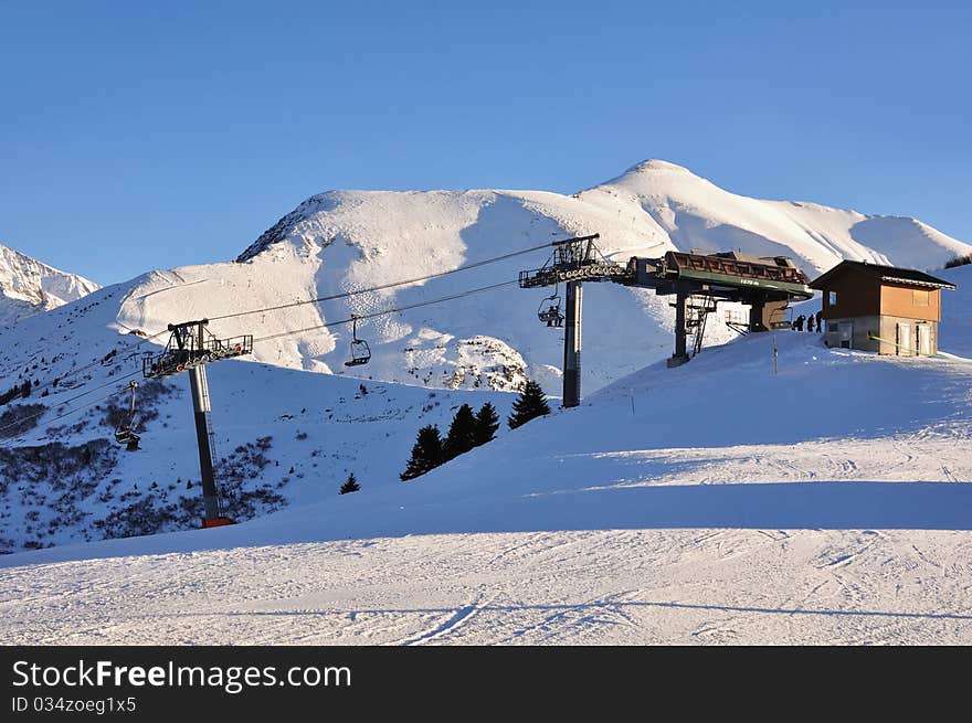 Arrival of lifts to mountain snow under a blue sky