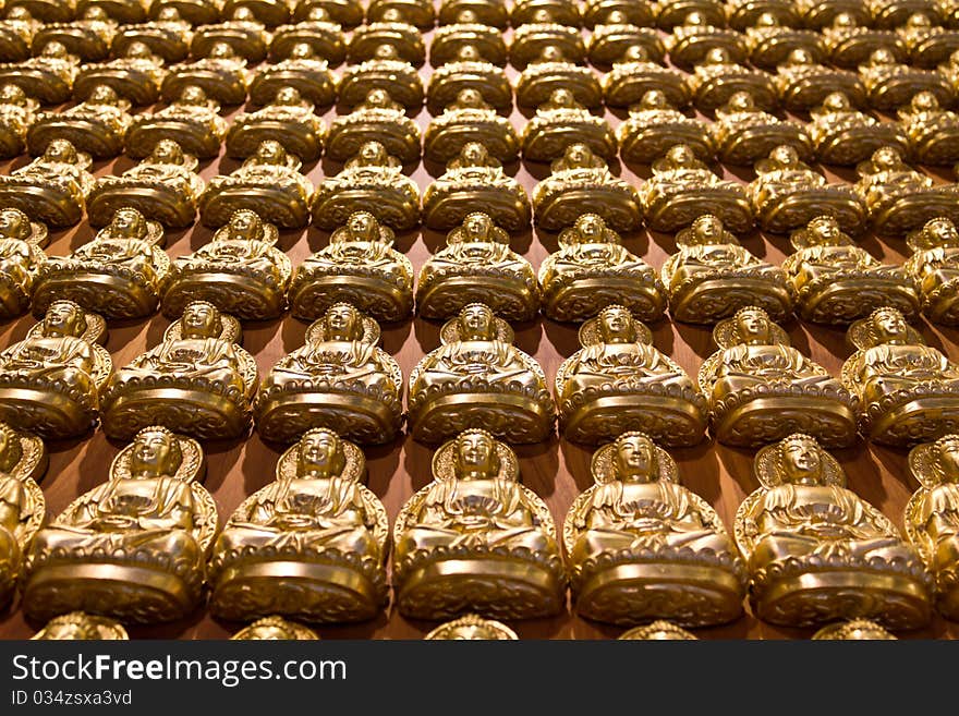 A lot of buddha images on wall in chinese temple Thailand