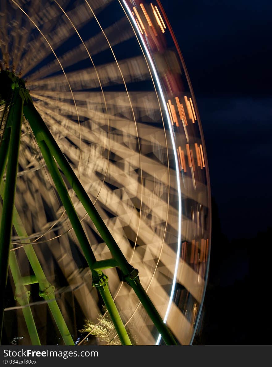 Ferris wheel turning around  in an amusement park