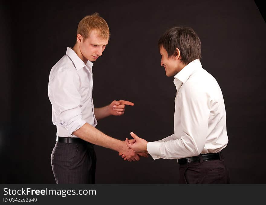 Portrait two adult man in business hand shake on black backdrop