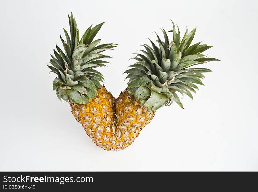 Twin ripe pineapple isolated on white background.