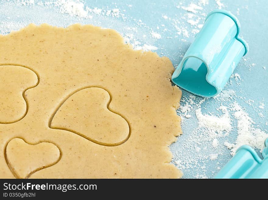 Making heart shaped shortbread cookies with cutters, dough