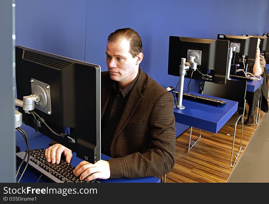 Man in library in computer local. Man in library in computer local