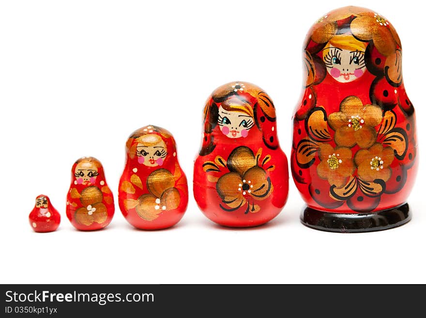 Russian nesting dolls stand in a row on a white background