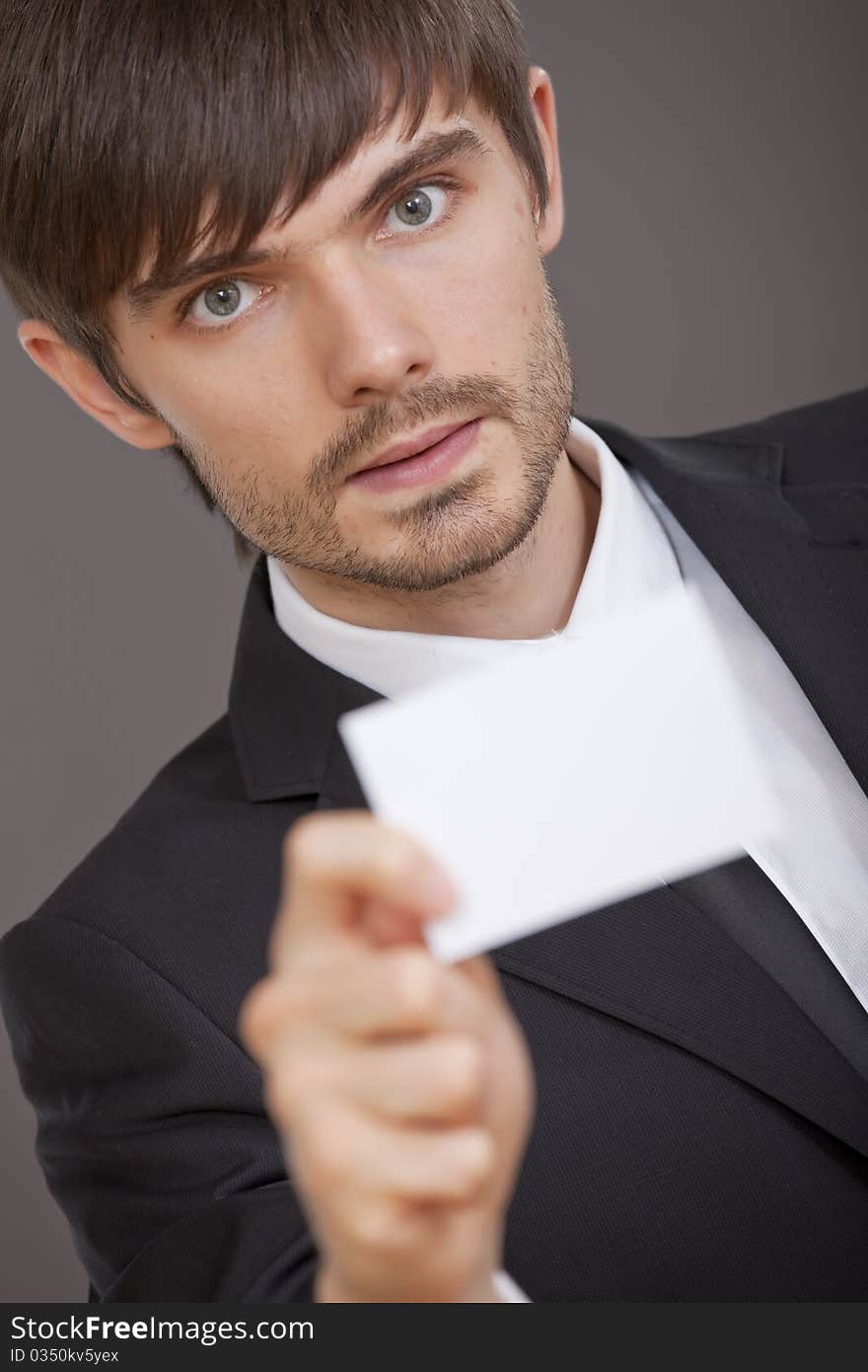 Young man showing business card in the camera. Young man showing business card in the camera