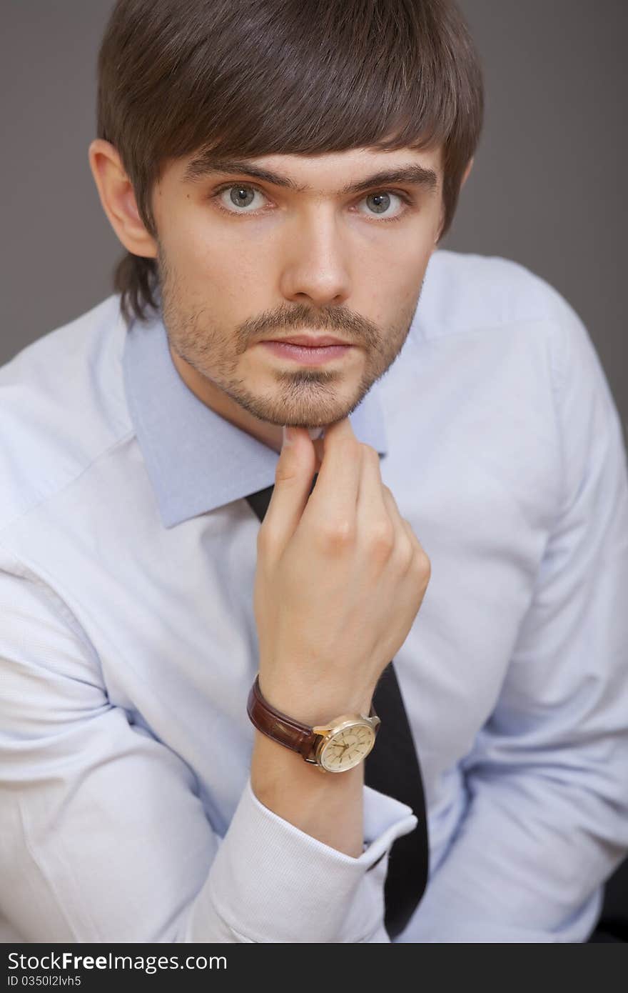 Portrait of male businessman over grey background. Portrait of male businessman over grey background