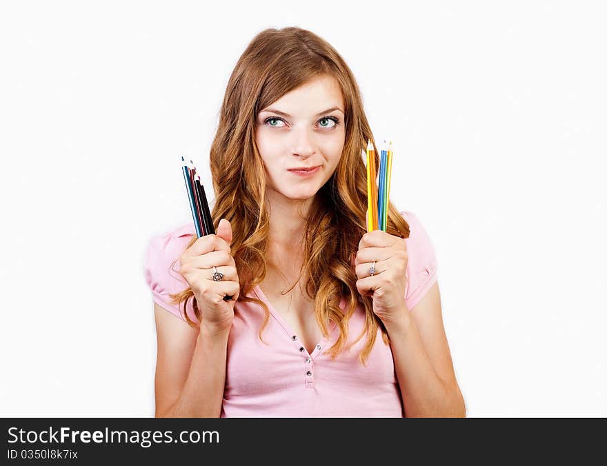 The joyful girl with color pencils on a white background