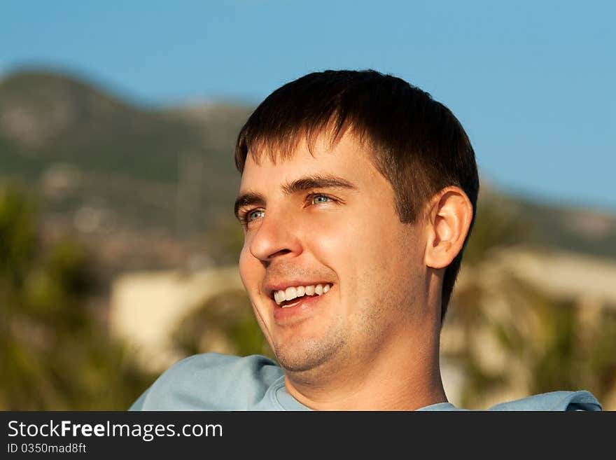 Portrait of a man against the backdrop of greenery