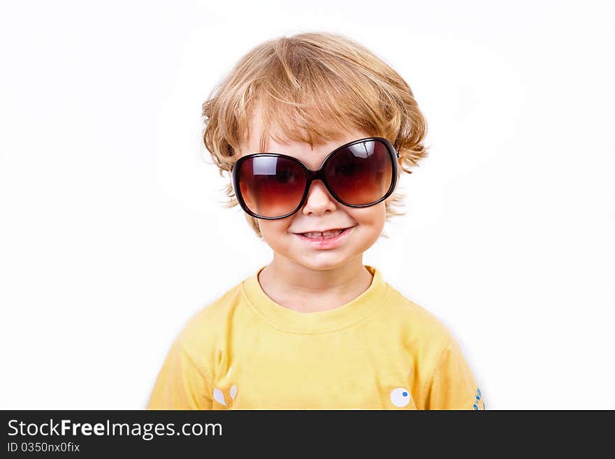 The joyful little boy with solar points on a white background