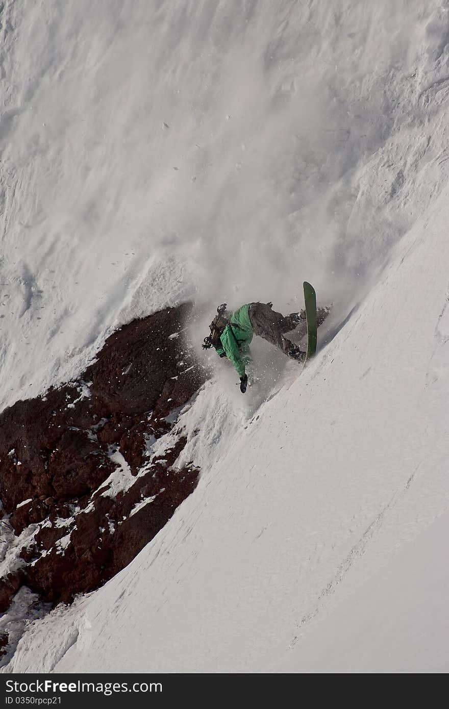 Freerider falling down the slope, Caucasus mountains