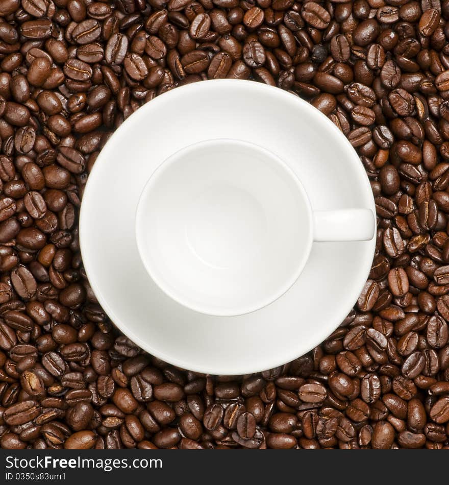 White coffee cup with plate and coffee beans. White coffee cup with plate and coffee beans.