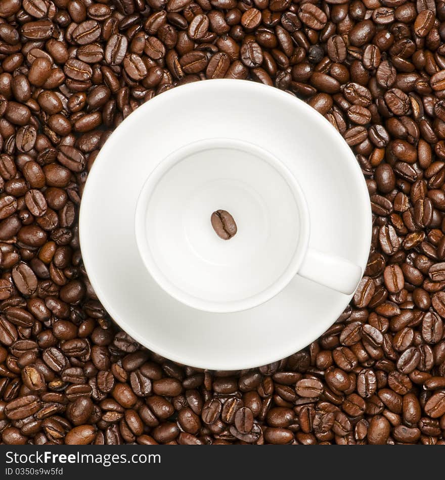 White coffee cup with plate and coffee beans. White coffee cup with plate and coffee beans.