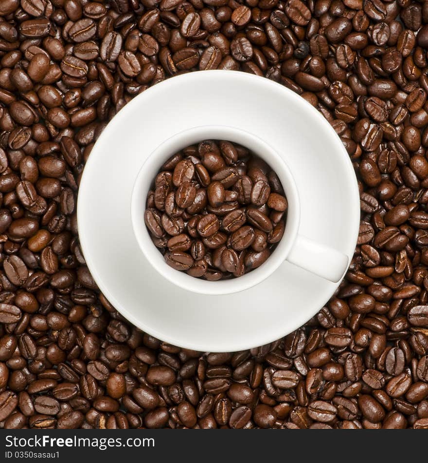 White coffee cup with plate and coffee beans. White coffee cup with plate and coffee beans.