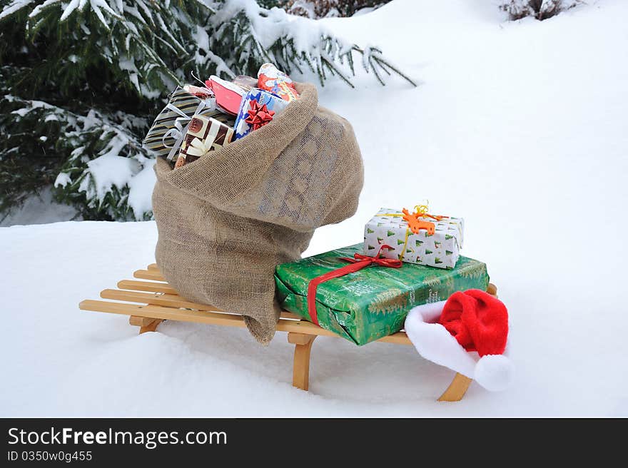 Bag of Christmas presents in the snow.